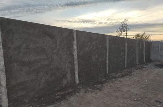 Cierre perimetral de concreto vibrado al atardecer.